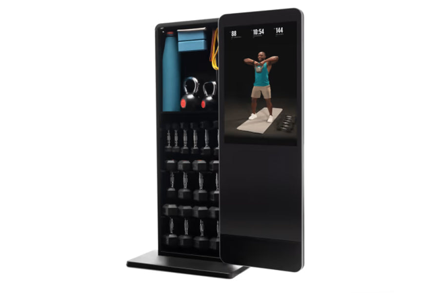 NordicTrack Vault black home gym mirror displaying workout video on screen with storage shelves holding dumbbells and accesso