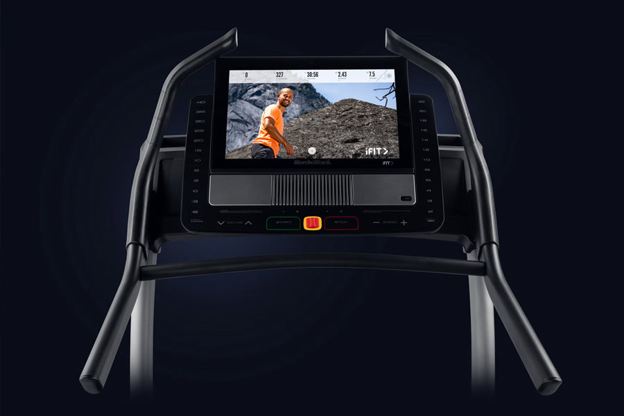NordicTrack X22i Commercial Treadmill with interactive touchscreen displaying workout video, black frame with dual handles, c