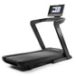 Black NordicTrack commercial treadmill with digital touchscreen console mounted on curved handlebars, wide running deck, on w