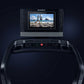 NordicTrack 1750 Commercial Treadmill with black frame, digital display screen showing beach workout scene, and control conso