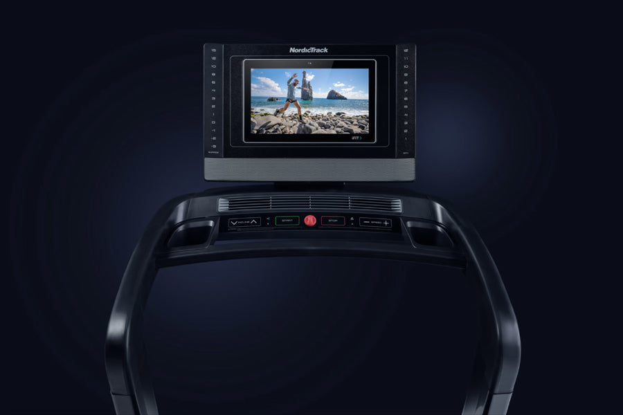 NordicTrack 1750 Commercial Treadmill with black frame, digital display screen showing beach workout scene, and control conso