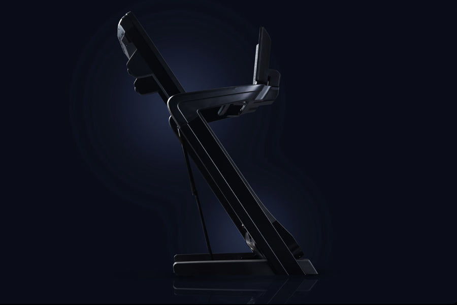 Black commercial treadmill with incline capability and digital console, shown at angle on dark blue background
