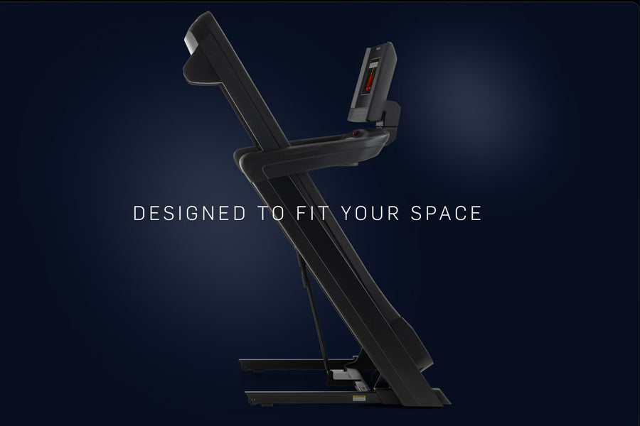 Black NordicTrack 1250 Commercial Treadmill with digital console and extended handrails on dark blue background