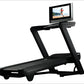 Black NordicTrack 2450 commercial treadmill with digital touchscreen displaying running workout on white background