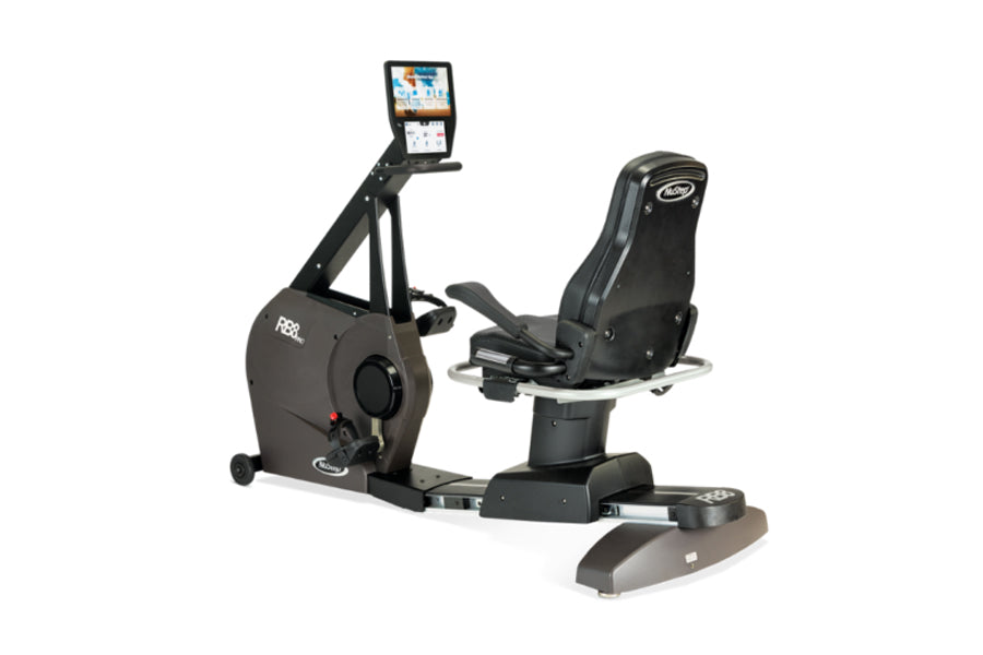Black recumbent exercise bike with digital display monitor and padded seat, viewed from the side on white background