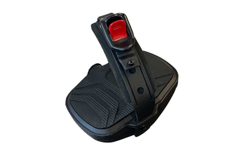 Black recumbent exercise bike pedal with red button and textured footpad, displayed on white background