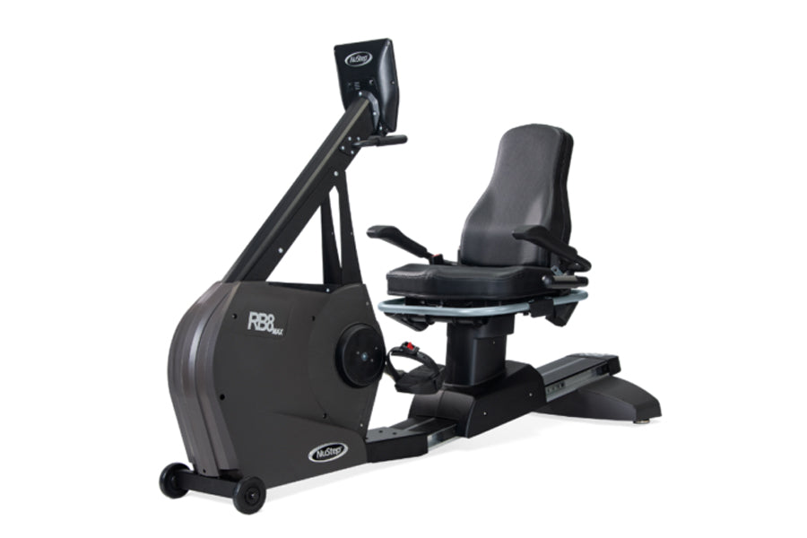 Black NuStep RB8PRO recumbent exercise bike with padded gray seat, digital display console, and rolling base on white backgro