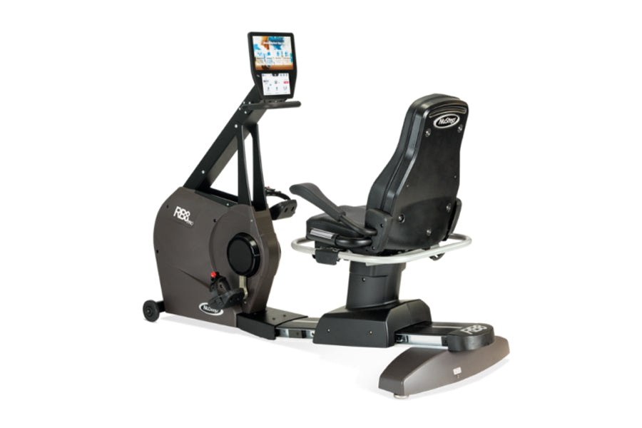 Black and gray NuStep RB8PRO recumbent exercise bike with digital display console, padded seat, and footrest on white backgro
