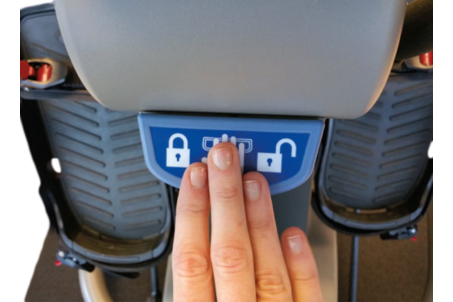 Hand pressing blue control panel with lock and function icons on NuStep recumbent elliptical stepper