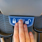 Hand touching blue touchscreen panel with lock and program icons on NuStep T5XR recumbent elliptical stepper