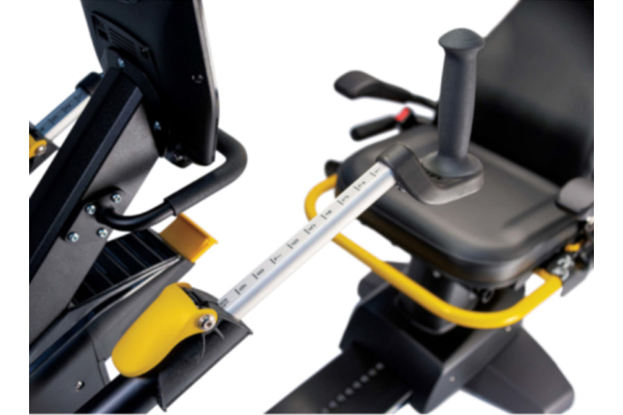 Black and yellow recumbent elliptical stepper with padded seat, foot pedals, and handlebar controls on white background