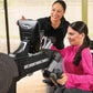 Two women using NuStep UE8PRO upper body ergometer machine with black and gray frame in gym setting
