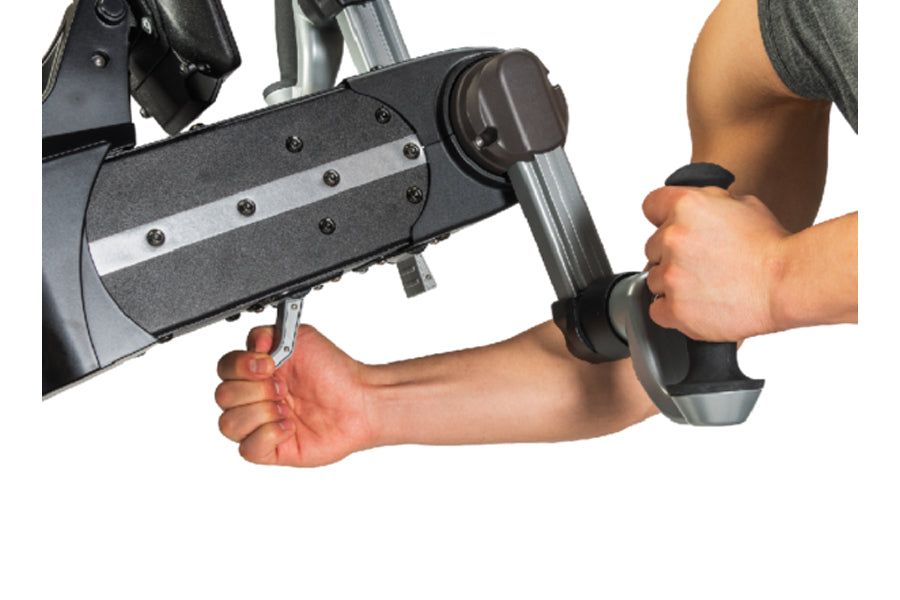 Person's arms gripping handles of black and gray upper body ergometer machine on white background