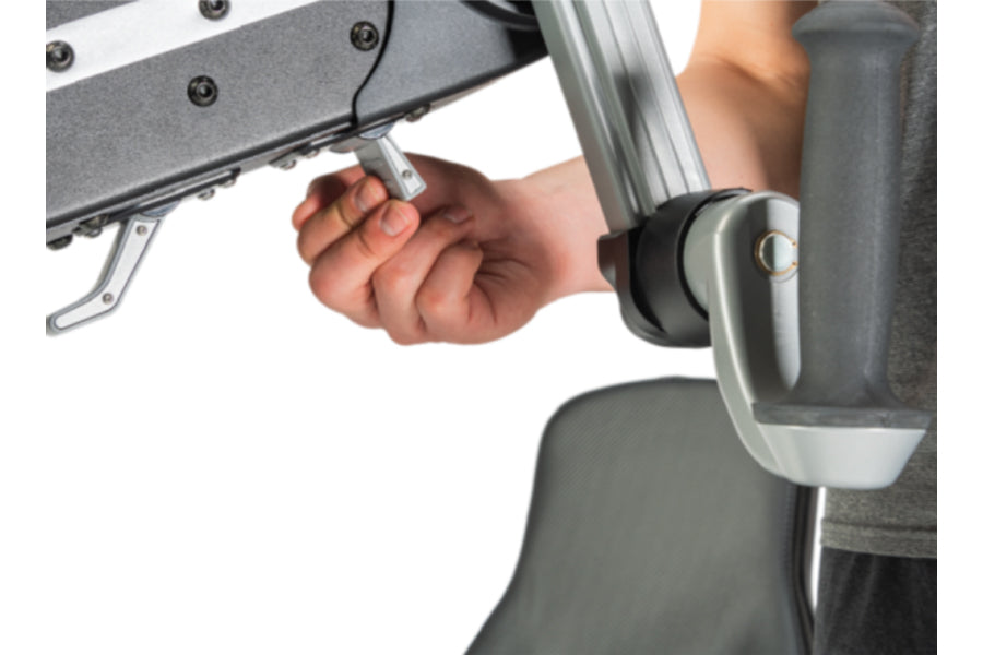 Hand gripping handle of NuStep UE8PRO upper body ergometer with gray padded seat visible, shown in use on white background