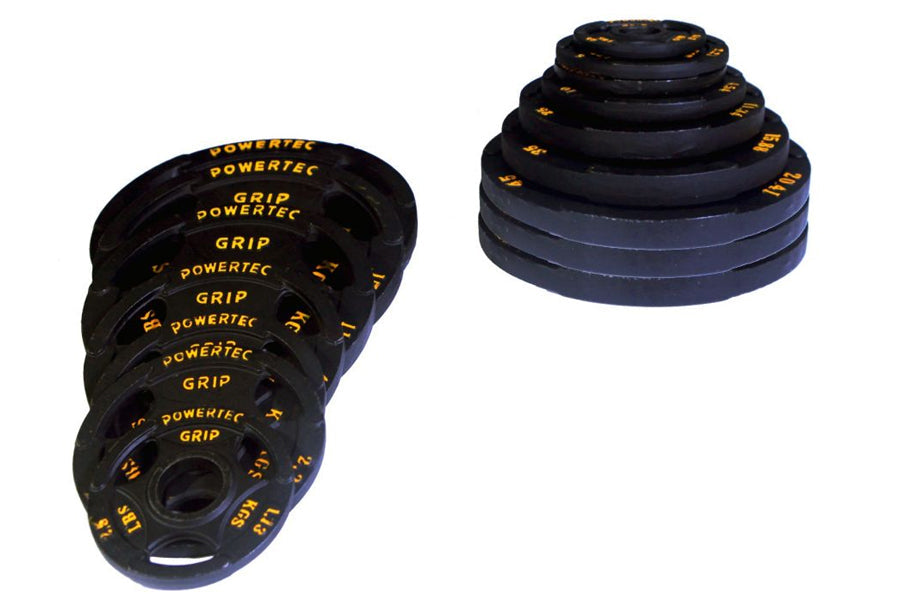 Powertec Olympic weight plates set with black rubber coating and yellow text markings, displayed in flat lay on white backgro