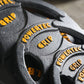 Powertec Olympic weight plates in gray with yellow text and grip handles, stacked in flat lay view
