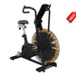 Black Octane Fitness AirdyneX exercise bike with large fan wheel featuring black and gold spokes, curved handlebars, padded s