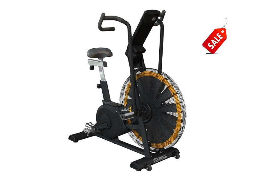 Black Octane Fitness AirdyneX exercise bike with large fan wheel featuring black and gold spokes, curved handlebars, padded s
