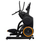 Black and orange commercial elliptical climbing machine with dual handles and large pedals on white background