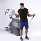 Man wearing black t-shirt and blue shorts using Octane Q47x gray and white elliptical machine with jump rope on white backgro
