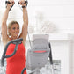 Woman in red tank top using gray and white Octane Q47x elliptical machine with black handles in bright home gym setting