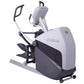 Gray and black elliptical cross trainer with moving handles, footpedals, and tablet holder mounted on white background