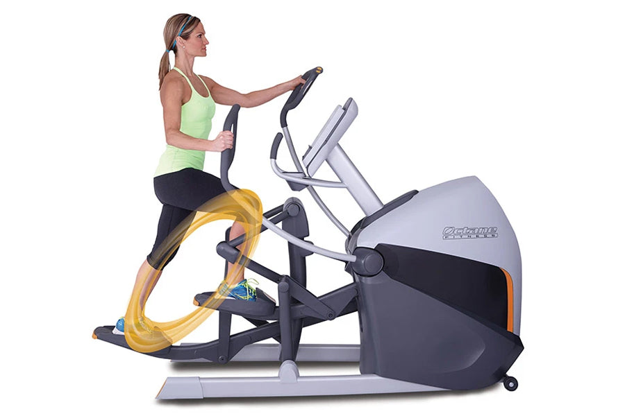 Woman wearing lime green tank top and black pants using gray and black Octane XT-One elliptical with yellow accent on pedals