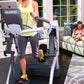 Woman in yellow tank top using Octane Fitness ZR7 Zero Runner treadmill with gray and white frame in home gym setting