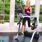 Woman exercising on white and black Octane Fitness ZR7 Zero Runner machine in bright home gym with large windows