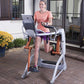 Woman in coral t-shirt and purple shorts using white and gray Octane Fitness ZR7 Zero Runner exercise machine on patio with y