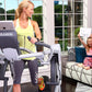Woman wearing yellow tank top and gray leggings on Octane Fitness ZR7 Zero Runner elliptical machine in bright room with wind