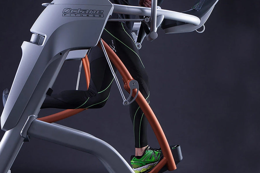 Silver and black Octane Fitness ZR8 Zero Runner with copper frame and green accents, shown with model wearing green sneakers
