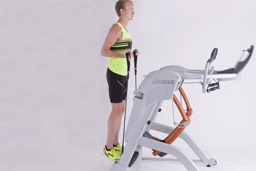 Man wearing neon yellow striped tank top and black shorts using white and orange Octane Fitness ZR8 Zero Runner machine again