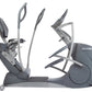 Gray and silver recumbent elliptical machine with dual handlebars and foot pedals, shown on white background