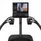 Black TRUE Palisade Climber with curved handlebars, vertical post, and display screen showing workout content, front view