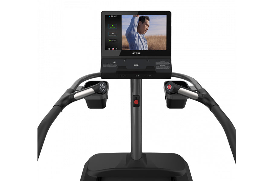 Black TRUE Palisade Climber with curved handlebars, vertical post, and display screen showing workout content, front view