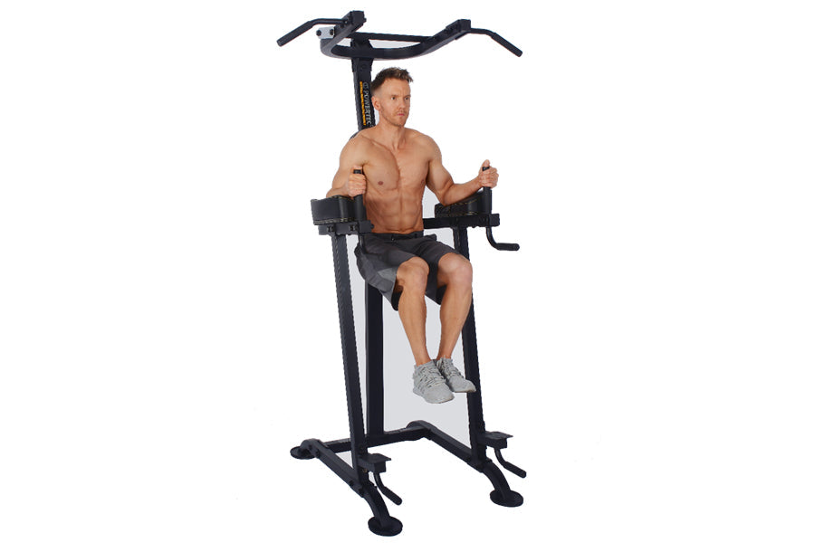 Male model demonstrating black Powertec Power Tower with overhead pull-up bar and leg raise station, worn on white background