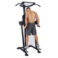 Black and gray vertical power tower with pull-up bar, dip station, and leg raise attachment, demonstrated by shirtless man we
