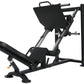 Black and silver leg press machine with padded seat and foot platform, on white background