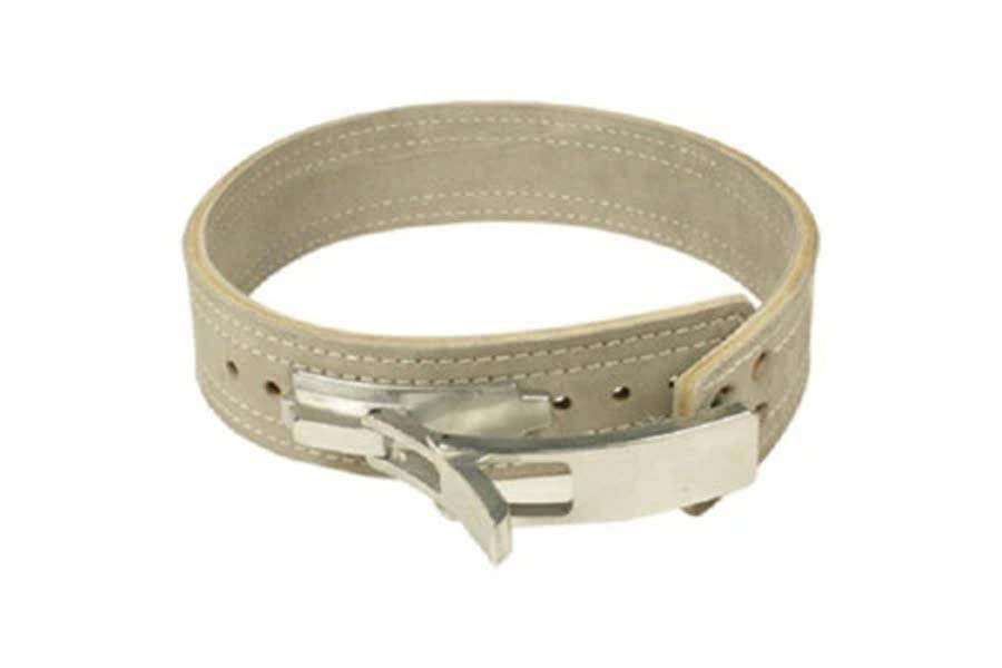 Beige leather bench belt with single thick construction, silver lever buckle closure, and decorative stitching on white backg