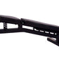 Black adjustable weight bench with padded seat and backrest, metal frame with leg extension attachment on white background