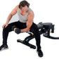 Man performing dumbbell exercise on black adjustable weight bench with foot platform, wearing gray tank top and black pants