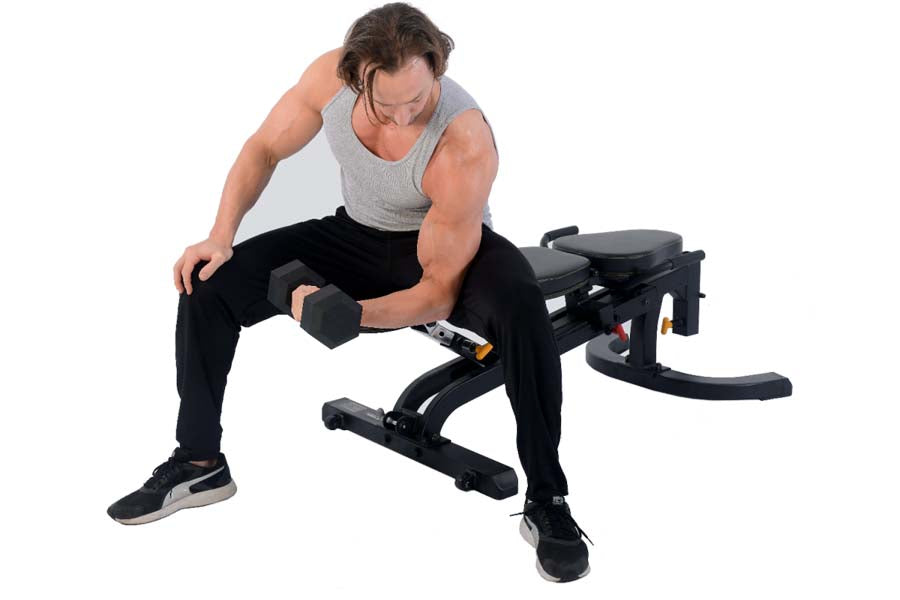 Man performing dumbbell exercise on black adjustable weight bench with foot platform, wearing gray tank top and black pants