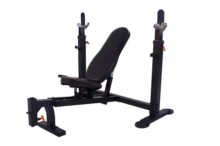 Black Olympic weight bench with adjustable backrest, leg extension, and dual squat racks on white background