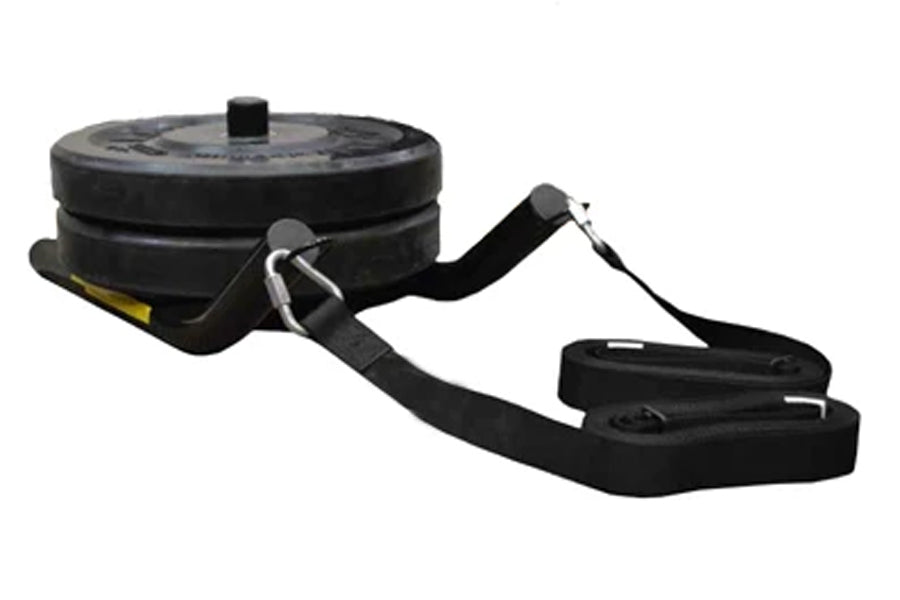 Black pull sled with tire weight plates, metal handle attachments, and adjustable black straps on white background