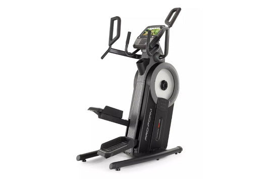 Black and gray upright exercise bike with digital touchscreen display, dual moving handlebars, and textured foot pedals on wh