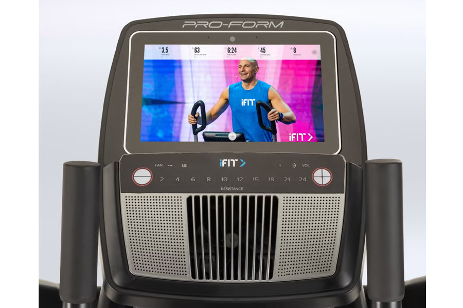 ProForm Carbon HIIT H10 elliptical with touchscreen display showing iFIT workout class, black frame with gray speakers and re