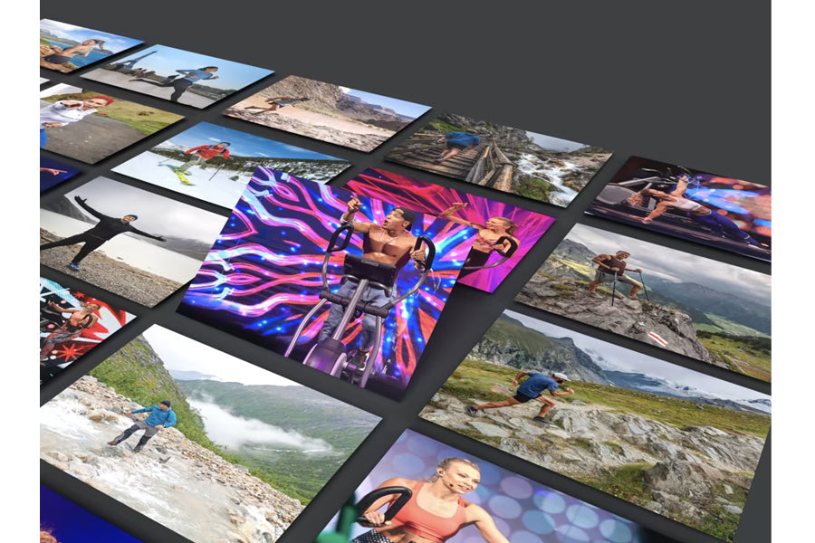 Collection of printed photos arranged in overlapping diagonal layout on gray background, featuring landscape scenes and neon-