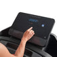 Hand touching control console of black ProForm treadmill with blue digital display showing speed, worn by model on white back
