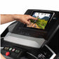 Hand touching touchscreen display on black ProForm treadmill showing outdoor running scene, with control panel and red emerge